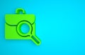 Green Magnifying glass with briefcase icon isolated on blue background. Job hunting. Work search concept. Unemployment