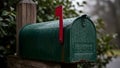 A green mailbox with a red flag sits in the rain Royalty Free Stock Photo