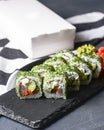 Green Maki Sushi - roll made of smoked salmon, cream cheese and cucumber inside. Dill outside. Royalty Free Stock Photo