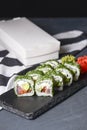 Green Maki Sushi - roll made of smoked salmon, cream cheese and cucumber inside. Dill outside. Royalty Free Stock Photo