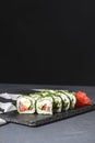 Green Maki Sushi - roll made of smoked salmon, cream cheese and cucumber inside. Dill outside. Royalty Free Stock Photo