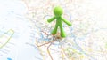 A green man plastic figure standing on Rome on a map of Italy