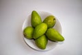 Green mangoes in a bowl