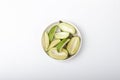 Green mangoes slices for pickle in white plate Royalty Free Stock Photo