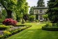 a green manicured garden in front of an italianate house with a belvedere