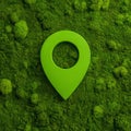 A green map marker rests on moss-covered rocks, surrounded by lush green foliage Royalty Free Stock Photo