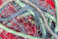 green marine rope and tangled red fishing net close-up in. pile Royalty Free Stock Photo