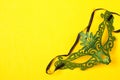 Green mask on yellow background Royalty Free Stock Photo