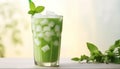 Green matcha bubble tea with ice cubes in cup on white wooden table over light green background softlight Royalty Free Stock Photo