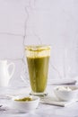 Green matcha cheese tea in a glass on the table. Homemade trendy drink. Vertical view Royalty Free Stock Photo