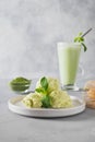 Green matcha ice cream and tea in latte glass on grey table Royalty Free Stock Photo