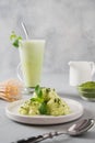 Green matcha ice cream and tea in latte glass on grey table Royalty Free Stock Photo