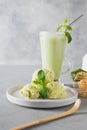 Green matcha ice cream and tea in latte glass on grey table Royalty Free Stock Photo