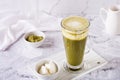 Green matcha ice tea with cream cheese in a glass on the table. Trendy homemade drink Royalty Free Stock Photo