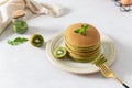 Green matcha pancakes with matcha tea or spinach. Healthy breakfast with superfoods. Light background, hugge scandinavian style. Royalty Free Stock Photo