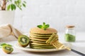 Green matcha pancakes with matcha tea or spinach. Healthy breakfast with superfoods. Light background, hugge scandinavian style. Royalty Free Stock Photo