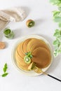 Green matcha pancakes with matcha tea or spinach. Healthy breakfast with superfoods. Light background, hugge scandinavian style. Royalty Free Stock Photo