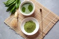 Green matcha tea drink and tea accessories on white background. Royalty Free Stock Photo