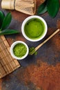 Green matcha tea drink and tea accessories on dark rusty background Royalty Free Stock Photo