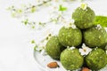 Green matcha tea energy balls or energy bites with spring blossoming flowers. Raw vegan food snack. Food styling Royalty Free Stock Photo