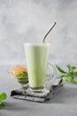 Green matcha tea and milk in latte glass on grey table Royalty Free Stock Photo