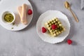 Green matcha tea tiramisu cake with raspberries on gray concrete background. Top view, copy space. Menu, confectionery, cafe Royalty Free Stock Photo