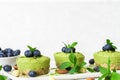 Green matcha vegan raw cakes with blueberries, mint and nuts. healthy delicious food Royalty Free Stock Photo