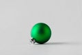 Green matte Christmas ball on a seamless grey background