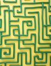Green maze pattern on yellow background. Abstract graphic design, graphic lines, simple shapes creating complex path. Graphic for Royalty Free Stock Photo