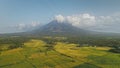Green meadow at Mayon volcano eruption aerial. Nobody nature landscape of cloudy fog above mount Royalty Free Stock Photo