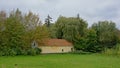 Meadow with old barn and trees in the Flemish countryside Royalty Free Stock Photo