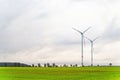 Green meadow with two wind turbine generating electricity Royalty Free Stock Photo