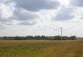 Green meadow under blue sky with clouds of white