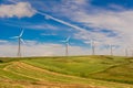 Green meadow with Wind turbines generating electricity Royalty Free Stock Photo