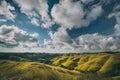 Green meadows on cloudy sky background. Sumba. Royalty Free Stock Photo