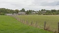 Fields with farms and houses and forests in the Wallonian countryside