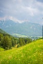 Green meadows with mountains and forest on backgound at sunset in summer, Italy Royalty Free Stock Photo