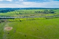 Green meadows and pastures with highway passing through.