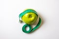 Green measuring tape over green apple. Diet and Healthy life, loss weight concept. Top view. Isolated. White background Royalty Free Stock Photo