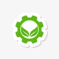 Green mechanical gear and green leaf sticker. Isolated on white background. Eco friendly technology icon