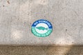 Green medallion with a fish on it and the words `No Dumping Drains To Bay Royalty Free Stock Photo