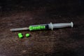 Green medicine in syringe put on the table Royalty Free Stock Photo