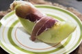 Green melon with raw ham ready to savor