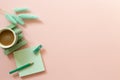 Green memo paper, colored pencil, cup of coffee, Lagurus ovatus dry grass on pink background Royalty Free Stock Photo