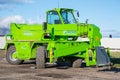 Green Merlo Roto telehandler parked at a construction site