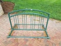 Green metal bike rack on red bricks with green grass Royalty Free Stock Photo