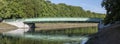 green metal bridge at a lake in Cologne, Decksteiner Weiher