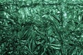 Green metal foil, wrinkled and shiny. Close-up, abstract image background Royalty Free Stock Photo