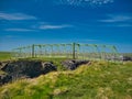 The green, metal footbridge that connects the archaeological site of Dun Eisdean to the northern coast of the Isle of Lewis