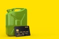 Green Metal Jerrycan and Black Plastic Golden Credit Card with Chip. 3d Rendering Royalty Free Stock Photo